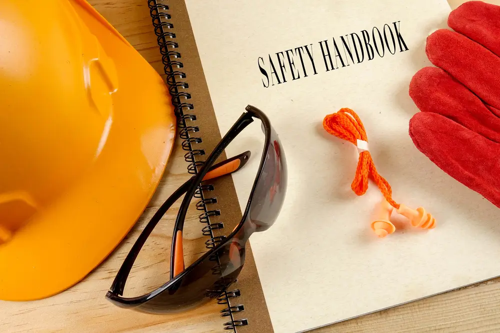 Construction workers wearing proper PPE during a safety briefing on site